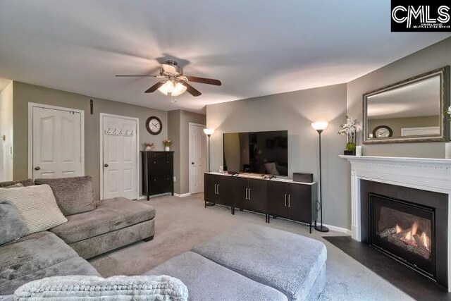 living room featuring carpet floors and ceiling fan