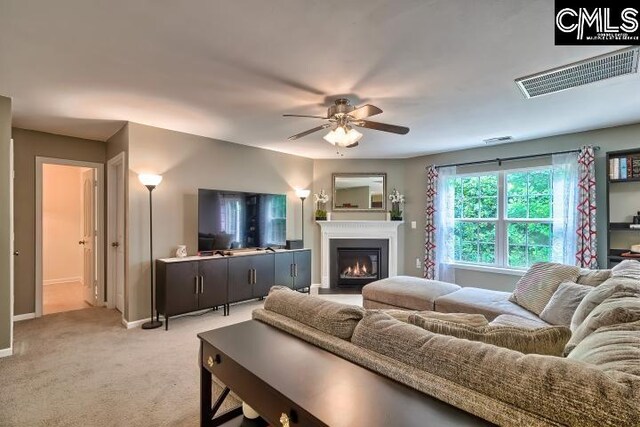 living room with light carpet and ceiling fan