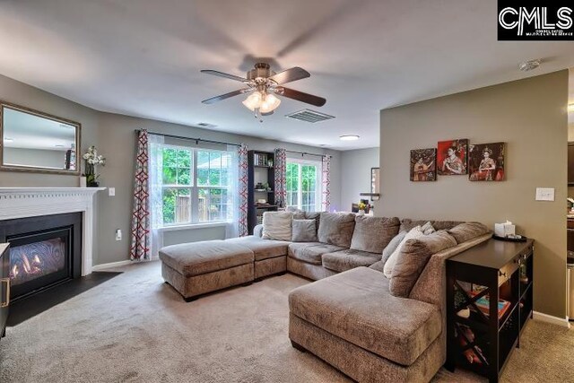 carpeted living room featuring ceiling fan