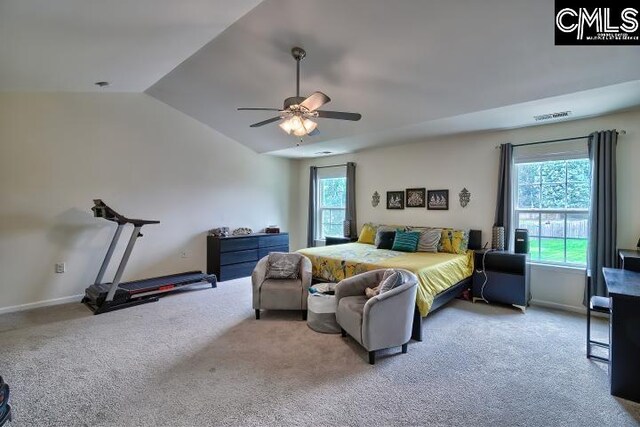 bedroom with carpet, multiple windows, ceiling fan, and vaulted ceiling