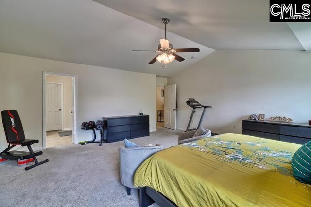 carpeted bedroom with ceiling fan and vaulted ceiling