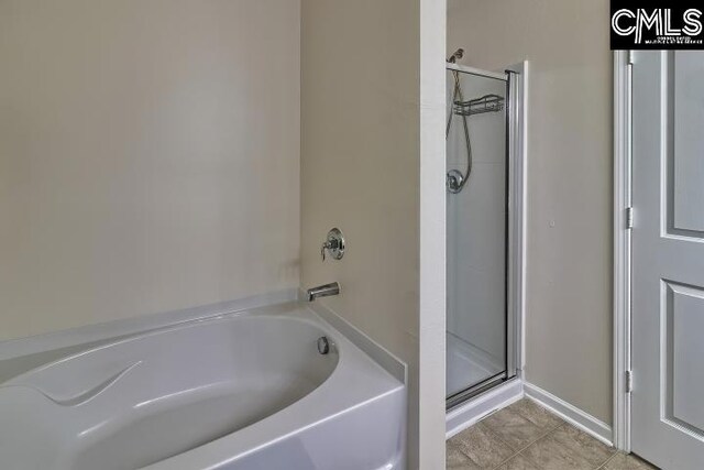 bathroom with tile patterned flooring and plus walk in shower