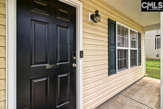 view of exterior entry featuring a porch