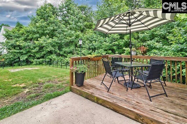 wooden deck with a lawn