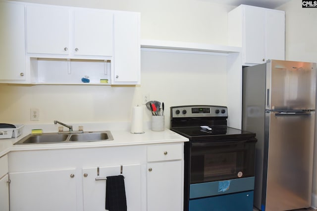 kitchen featuring stainless steel fridge, electric range, and white cabinetry