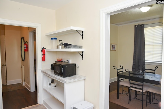 corridor with dark hardwood / wood-style floors