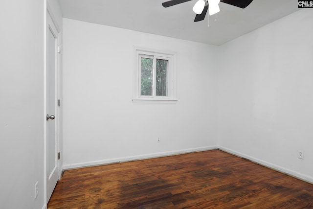 spare room with ceiling fan and dark wood-type flooring