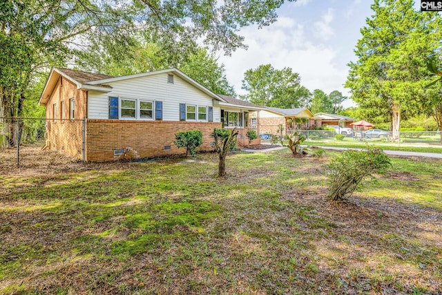 back of house with a lawn