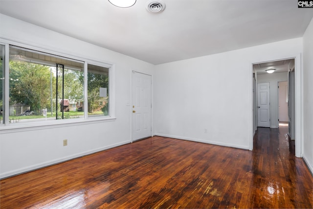 spare room featuring dark hardwood / wood-style flooring