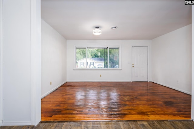 spare room featuring dark hardwood / wood-style floors