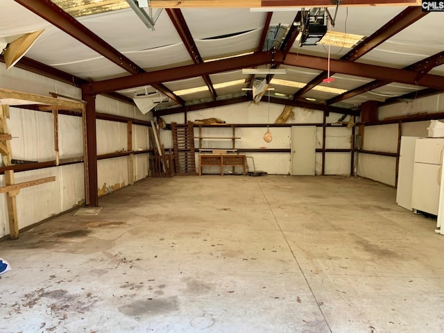 garage with white fridge and a garage door opener