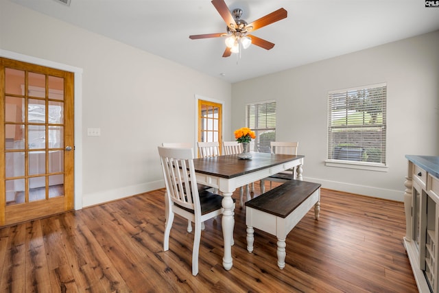 dining area featuring dark wood-type flooring and ceiling fan