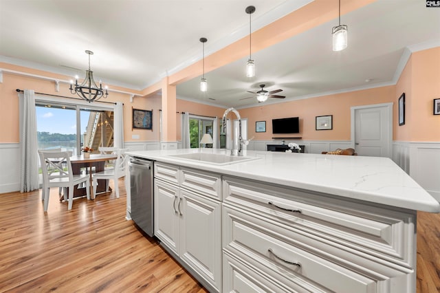 kitchen featuring light wood-type flooring, plenty of natural light, a kitchen island with sink, and sink