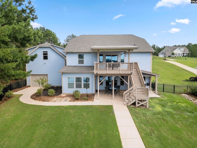 back of house featuring a wooden deck and a yard