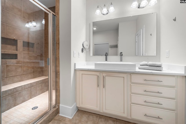 bathroom featuring tile patterned flooring, a shower with door, and vanity