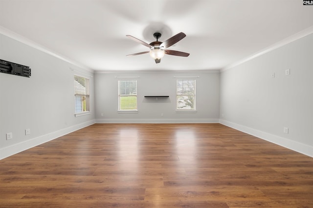 unfurnished living room with ornamental molding, ceiling fan, and dark wood-type flooring