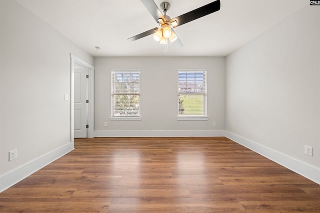 spare room featuring dark hardwood / wood-style flooring and ceiling fan