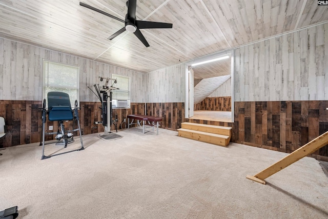 workout area with ceiling fan, wooden walls, lofted ceiling, and carpet floors