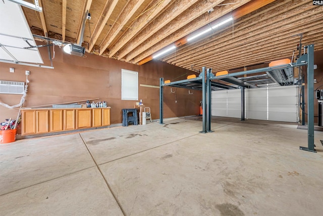 garage featuring a garage door opener and a wall unit AC