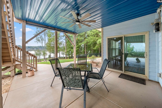 view of patio / terrace featuring a water view and ceiling fan