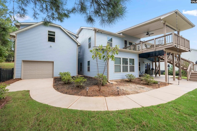 view of front of house with a front yard, a garage, and a deck