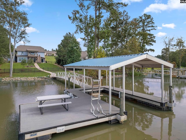 dock area with a water view and a yard