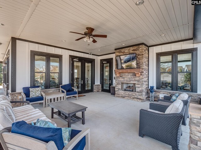 view of patio with an outdoor living space with a fireplace and ceiling fan