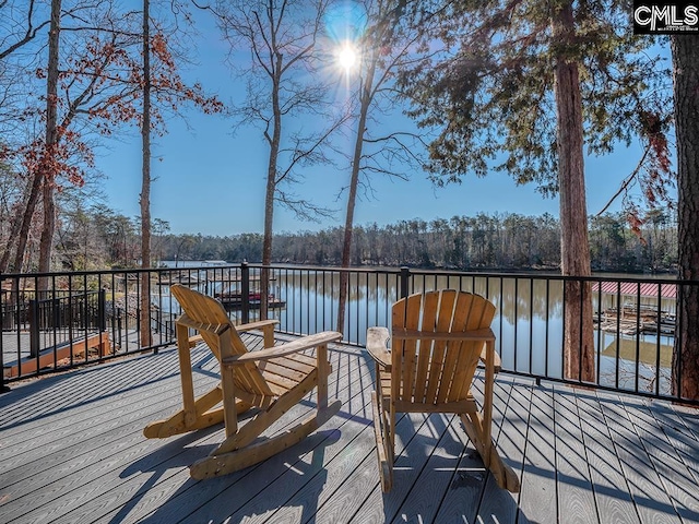 wooden terrace featuring a water view