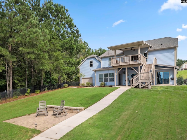 rear view of house with a yard, a patio area, a deck, and ceiling fan