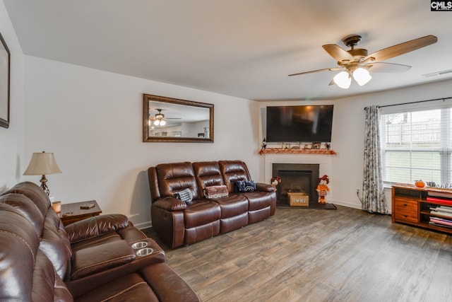 living room featuring ceiling fan and hardwood / wood-style floors