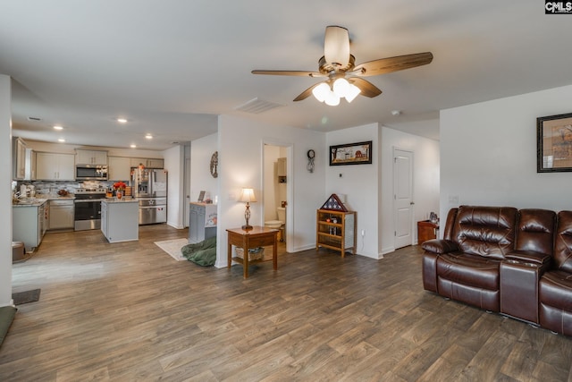 living room with hardwood / wood-style floors and ceiling fan