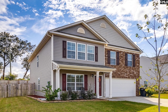 craftsman-style home featuring a front yard and a garage