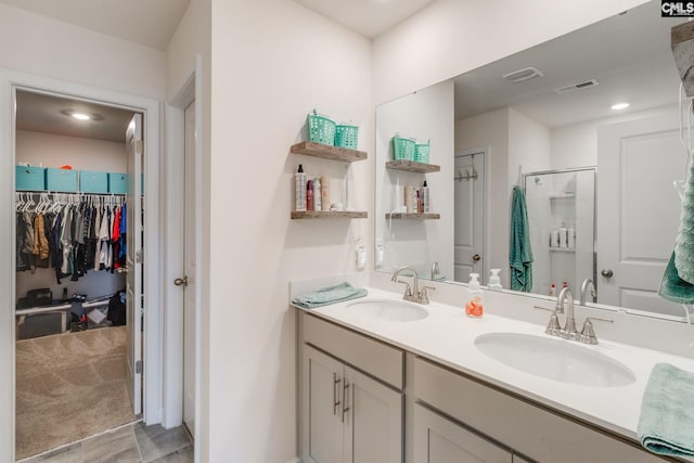 bathroom with walk in shower and vanity