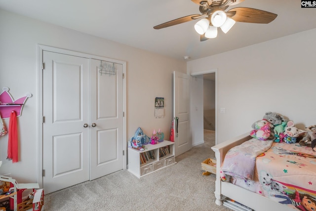 carpeted bedroom featuring ceiling fan and a closet