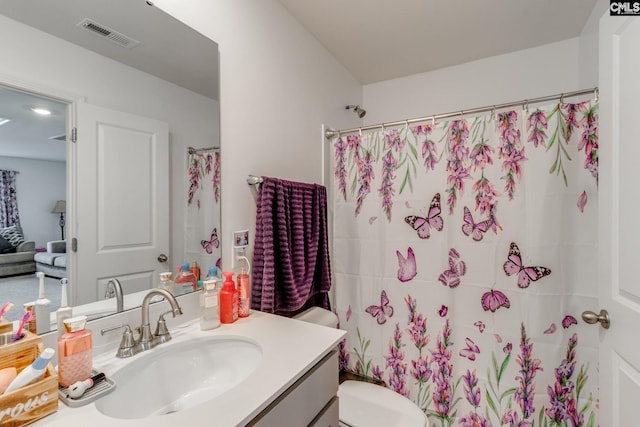 bathroom with vanity, toilet, and curtained shower