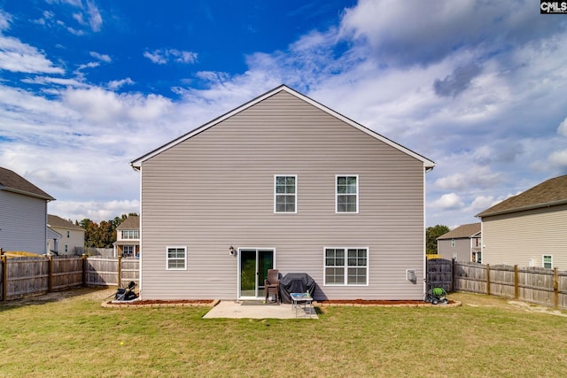 back of house featuring a patio area and a yard