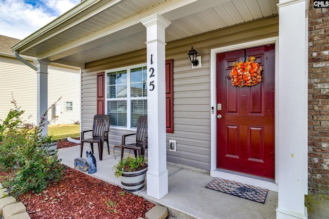 view of exterior entry with a porch