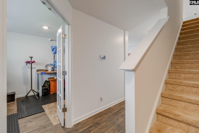 stairway with hardwood / wood-style flooring