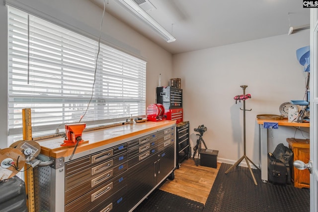 miscellaneous room featuring light hardwood / wood-style flooring and a workshop area