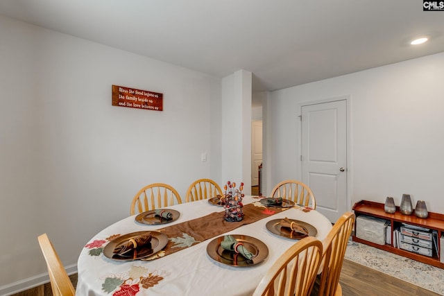 dining space with dark hardwood / wood-style floors