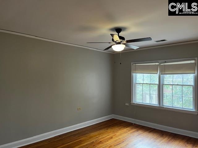 spare room featuring ornamental molding, ceiling fan, and hardwood / wood-style flooring