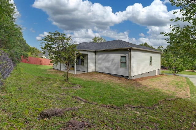 rear view of property with a lawn and a patio