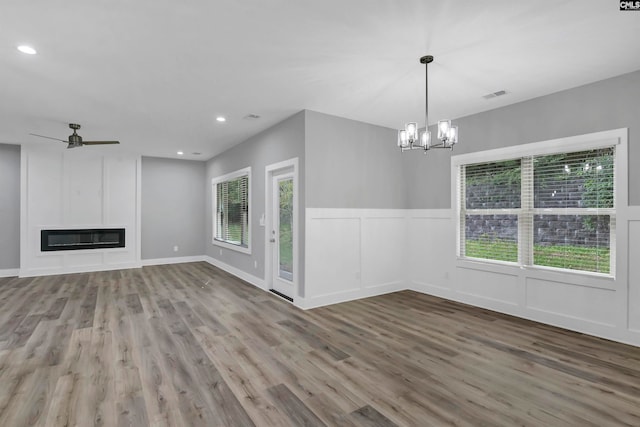 unfurnished living room featuring a fireplace, hardwood / wood-style floors, and a wealth of natural light