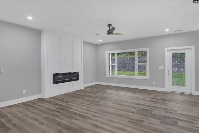 unfurnished living room with ceiling fan and light wood-type flooring