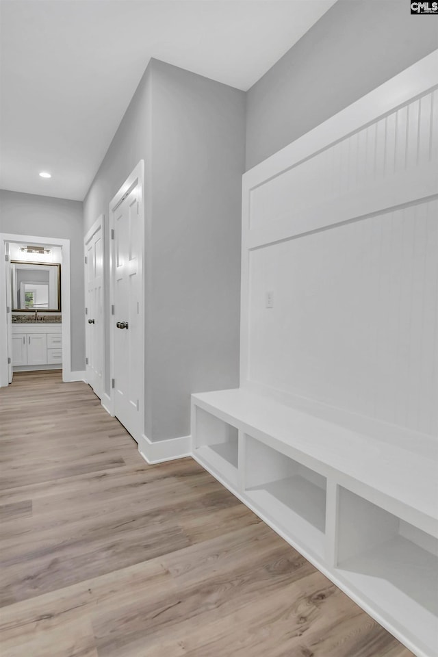 mudroom featuring light hardwood / wood-style flooring and sink