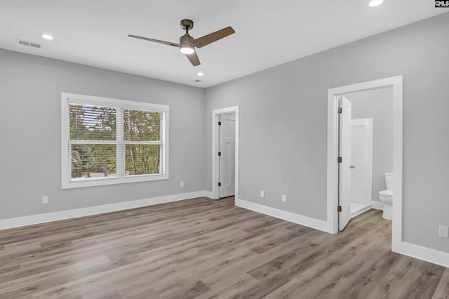 spare room with ceiling fan and light wood-type flooring