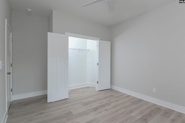 unfurnished bedroom with a closet, light hardwood / wood-style floors, and ceiling fan