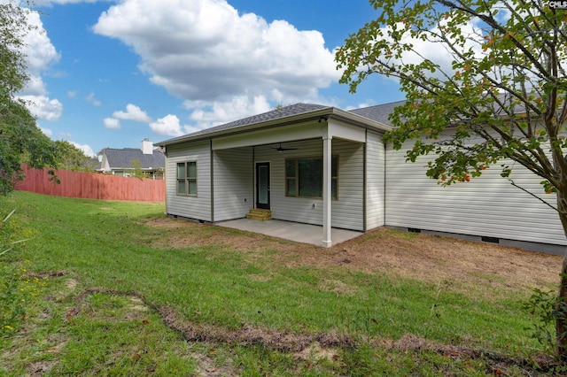 back of house with a lawn, ceiling fan, and a patio area