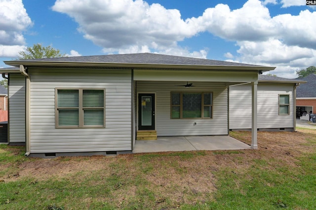 rear view of property with a patio, a lawn, and ceiling fan