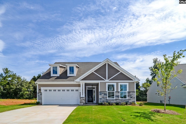 craftsman house with a front yard and a garage